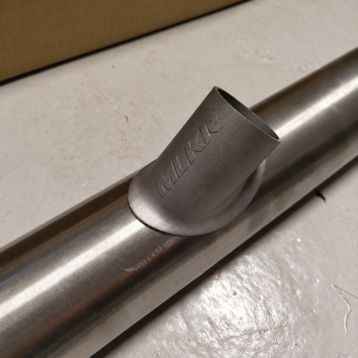 MLKR wastegate saddle merge positioned on exhaust tubing – angled view