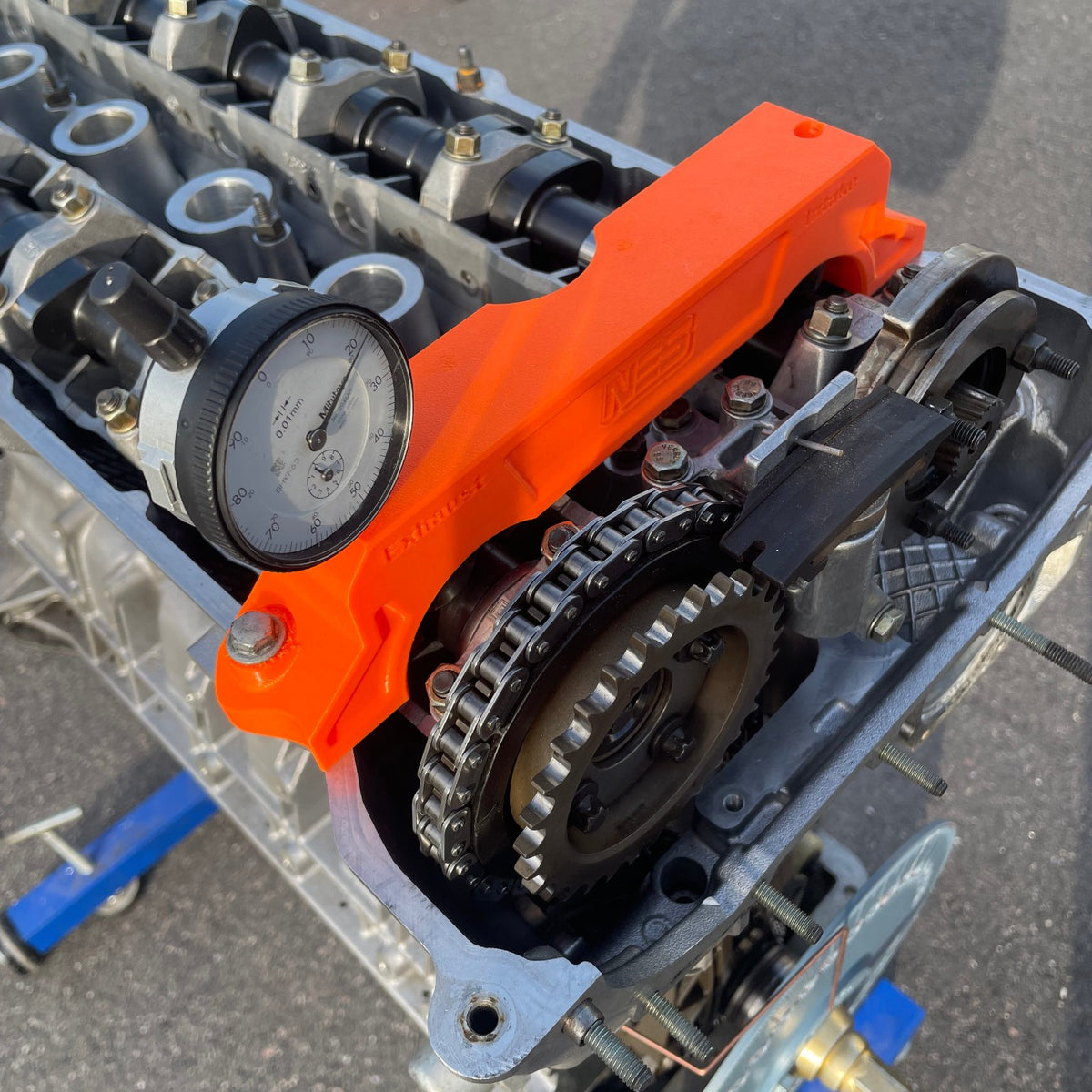 NES camshaft timing fixture mounted on BMW cylinder head; dial indicator not included
